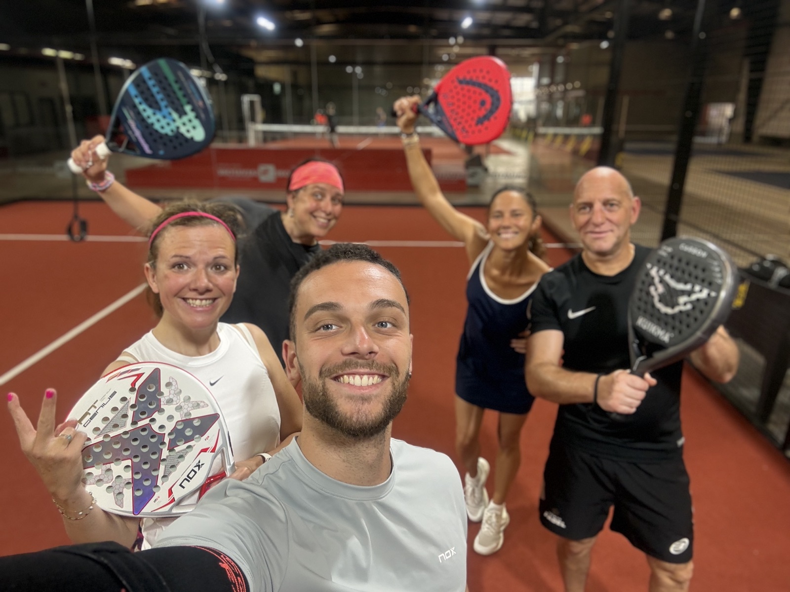 Kevin Padel with players and their rackets raised
